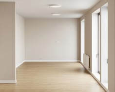 an empty room with white walls and wooden floors