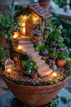 a fairy garden is lit up in the shape of a potted house with lights