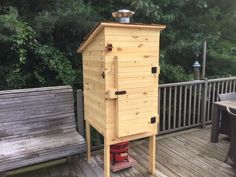 a wooden outhouse sitting on top of a deck