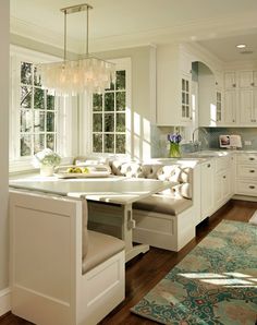 a large kitchen with white cabinets and an island in the middle, along with lots of windows