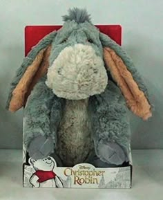 a gray stuffed animal in a red box