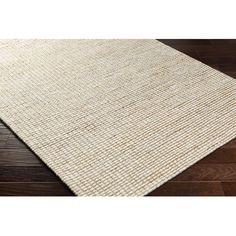 a white rug on top of a wooden floor