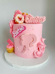 a pink cake decorated with flowers and candy