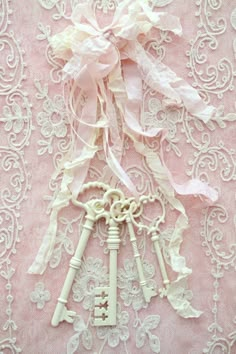 three keys are attached to a lace doily