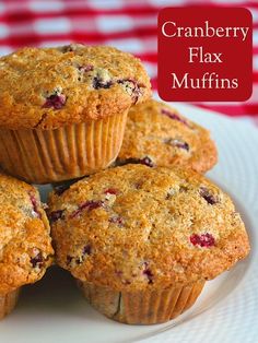 four blueberry muffins on a white plate