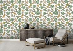 a chair and ottoman in front of a wallpapered with leaves on it's side