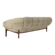 an upholstered sofa with four curved cushions on the back and legs, in beige fabric