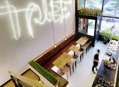 an overhead view of a restaurant with tables and chairs in front of a neon sign