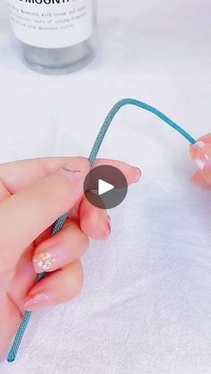 a person is holding a string that has been tied to the end of a toothbrush