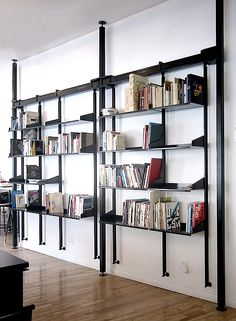 the bookshelves are lined up against the wall