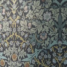 an intricately designed wallpaper with flowers and leaves on black, blue, yellow and green colors