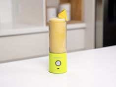 a yellow blender sitting on top of a white counter