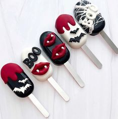 four pops decorated to look like vampire faces