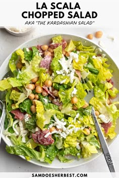 a salad with lettuce, chickpeas and parmesan cheese on top