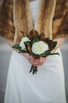 a woman holding a bouquet of flowers on her wedding day, with the caption'studio - bluush '