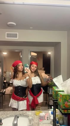 two women dressed in costumes taking a selfie