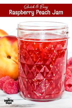 a jar filled with raspberry peach jam next to some fresh raspberries