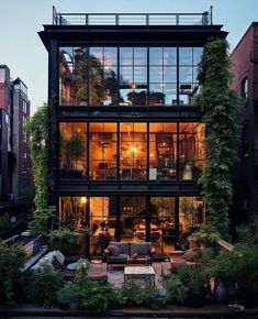 an apartment building with lots of windows and plants growing on the side of it's walls