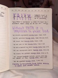 an open notebook with the words faith written in purple ink on white paper, sitting on top of a bed