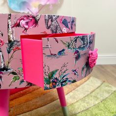 a pink table with flamingos painted on it