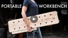 a woman holding a wooden board with holes in it and the words portable workbench