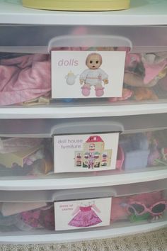 three plastic bins filled with dolls and other items