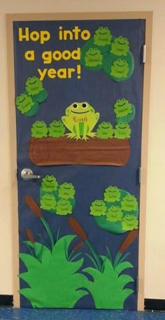 a door decorated to look like a frog with green leaves on it and the words hop into a good year