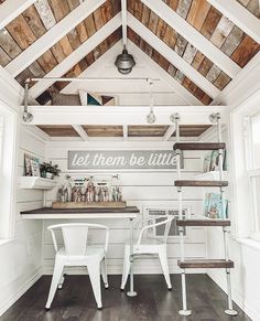 a room with white chairs and wooden walls that says let them be little on the wall