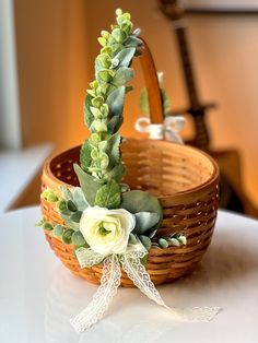 a flower arrangement in a basket on a table