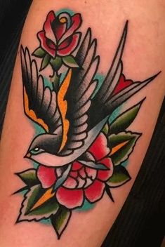 a bird with flowers on it's arm is shown in this tattoo style photo