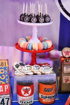 an assortment of desserts are displayed on a red tray with blue and white decor