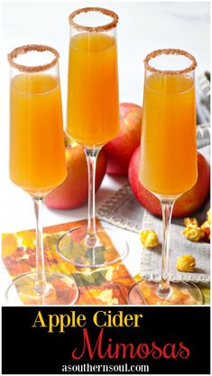 two glasses filled with apple cider mimosa on top of a table