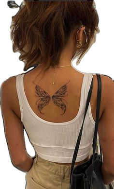 a woman with a butterfly tattoo on her back