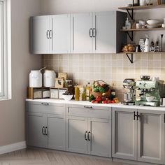 a kitchen filled with lots of counter top space next to a wall mounted microwave oven