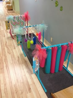 some pink and blue items are on the floor in front of a wall with decorations