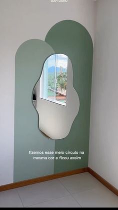 a mirror on the wall in a room with tile flooring and walls painted green