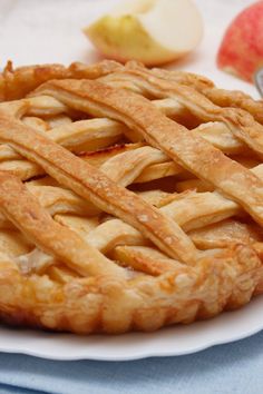 an apple pie sitting on top of a white plate