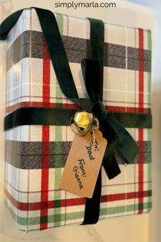 a wrapped present with a tag on it and the words simply martha written in gold