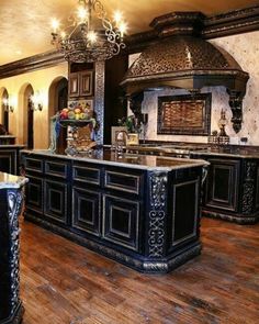 an ornate kitchen with wooden floors and black cabinets