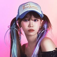 a girl with blue and purple hair wearing a baseball cap that reads rockstard