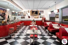 a restaurant with checkered floor and red booths