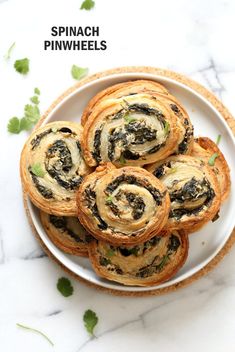 spinach pinwheels on a plate with text overlay that reads spinach pinwheels