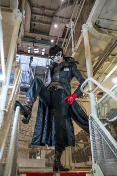 a man dressed as the joker climbing up some stairs