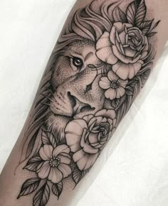 a black and white lion with flowers on his arm