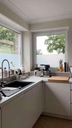 a kitchen filled with lots of counter top space next to a large window and sink