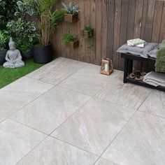 an outdoor patio with grass and potted plants