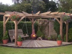 a wooden patio with swings and potted plants