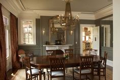 a dining room table with chairs and a chandelier