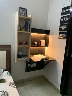 a room with a desk, bookshelf and lamp