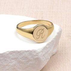 PRODUCT DESCRIPTION * Our Ladies 9ct Yellow Gold Personalised Round Signet Ring can be personalised with an initial to create a bespoke gift that can be worn every day. * Crafted from solid 9ct gold, its classic round design makes it suitable for ladies and women of all ages. *This engraveable signet ring becomes a unique and cherished keepsake, making it an ideal personalised gift. Treat yourself to a touch of luxury or surprise a loved one with this solid gold symbol of sentiment. Discover the Classic 14k Gold Initial Ring For Personalized Gift, Monogrammed Yellow Gold Rings As Personalized Gift, Personalized Initials 14k Gold Rings, Personalized 14k Gold Rings With Initials, Classic Personalized Rose Gold Initial Ring, Personalized Engraved Rose Gold Ring, Classic Rose Gold Initial Ring As A Gift, Personalized Initial Ring In Yellow Gold, Classic Rose Gold Initial Ring As Gift